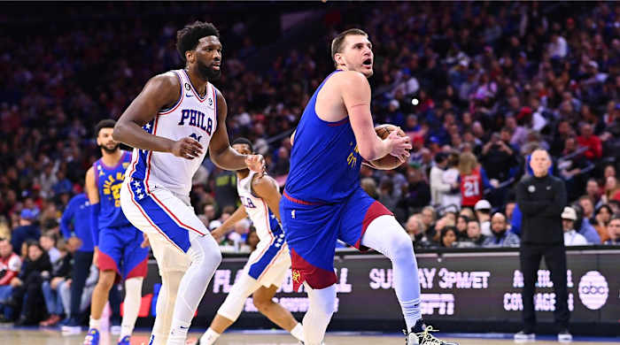 Jan 28, 2023; Philadelphia, Pennsylvania, USA; Denver Nuggets center Nikola Jokic (15) drives against Philadelphia 76ers center Joel Embiid (21) in the second quarter at Wells Fargo Center.